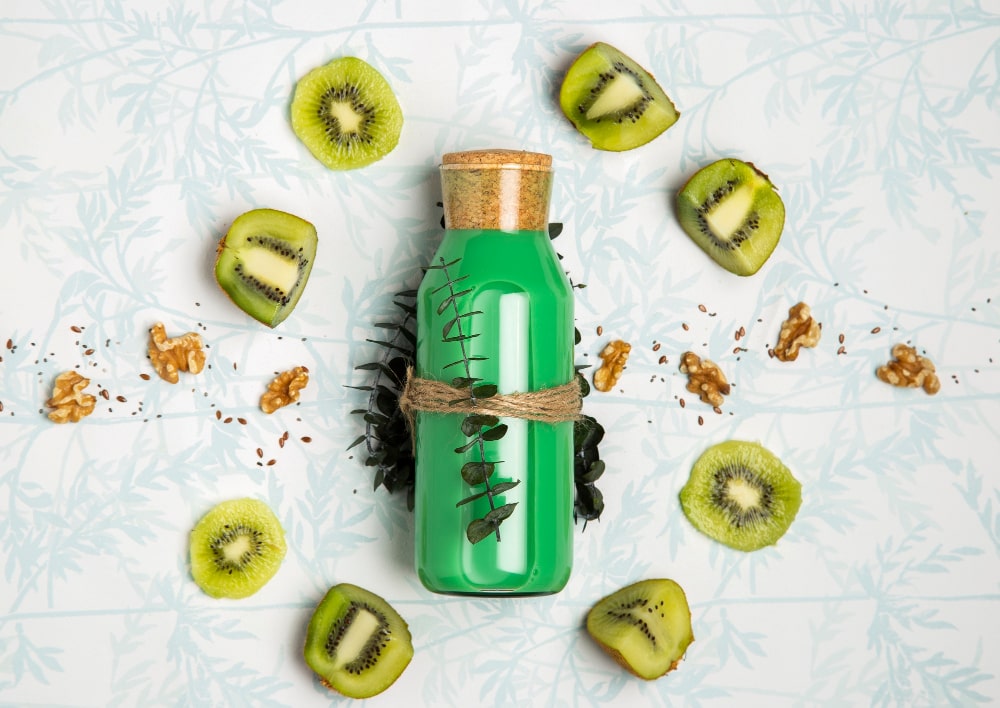 Green smoothie bottle with kiwis and walnuts, a healthy energy alternative